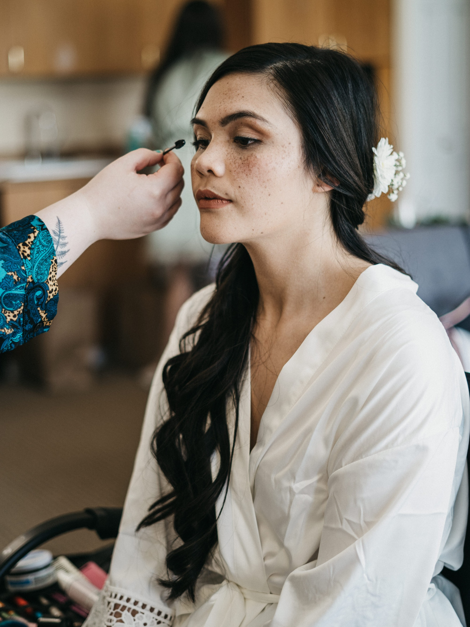 A BFE makeup artist working with a Bride during her wedding day preparations